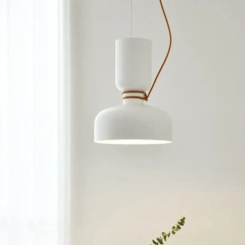 White ceramic pendant light with sleek cylindrical shade and brown leather cord featuring led bulb and wrought iron accents