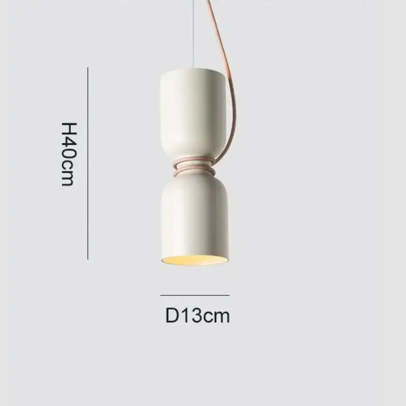 Cream-colored ceramic pendant light with copper-toned cord pendant and warm glow in Danish wrought iron kitchen style