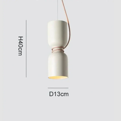 Cream-colored ceramic pendant light with copper-toned cord pendant and warm glow in Danish wrought iron kitchen style