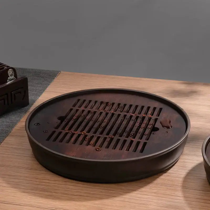 Dark brown bamboo tea tray with circular design and slatted tea tray drainage board for dining room kung fu tea