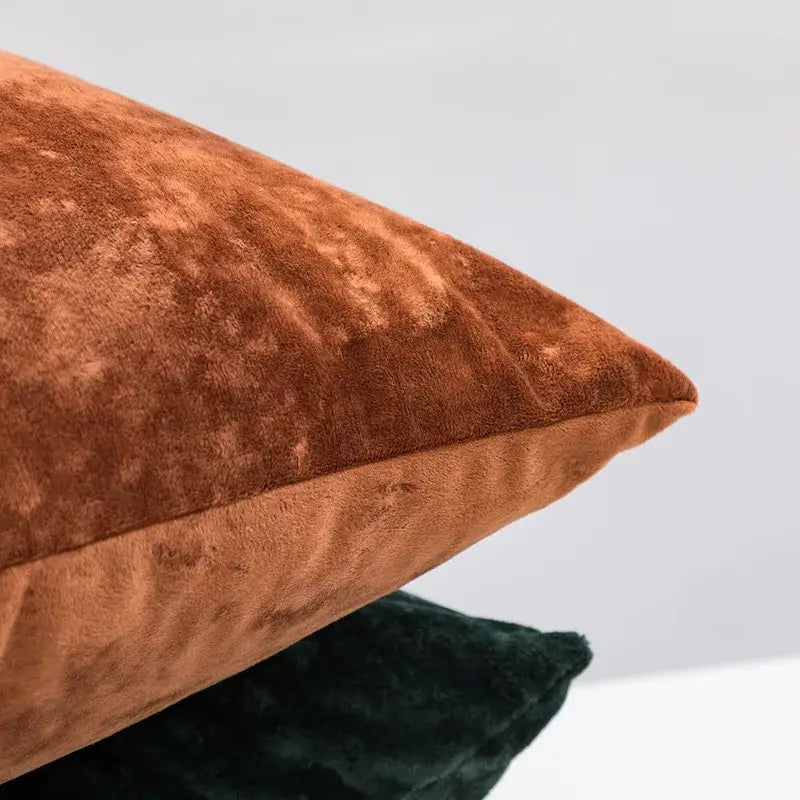 A plush rust-colored velvet pillow cover with a soft textured surface and neatly stitched edges for decorbites dark grain