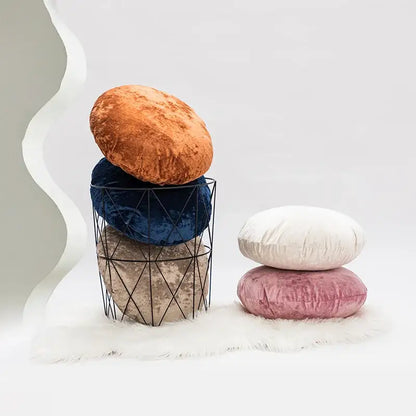 Stacked dark grain velvet pillow covers in warm orange navy blue and muted taupe in a black wire basket decorbites dark grain