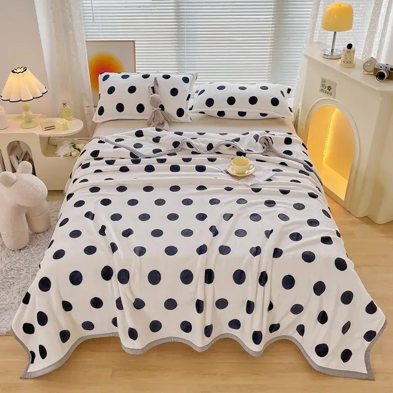 White fleece blanket with navy blue polka dots and gray trim for dark gray cartoon print flannel sofa cover decorbites