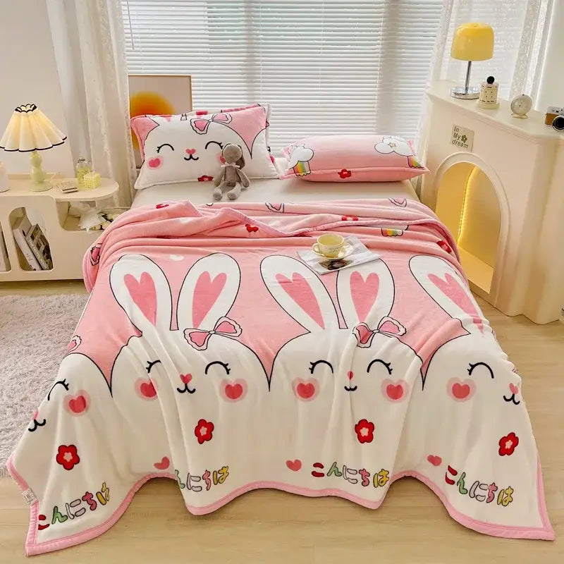 Dark gray cartoon print flannel sofa cover with pink and white bunny fleece blanket featuring embroidered hearts and japanese characters