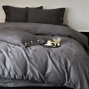 Dark gray egyptian cotton bedding set featuring satin-like fabric with floral embroidery and button detailing on pillowcases