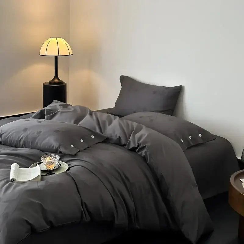 Dark gray egyptian cotton bedding set with satin-like texture, subtle dot patterns, and button details on pillowcases