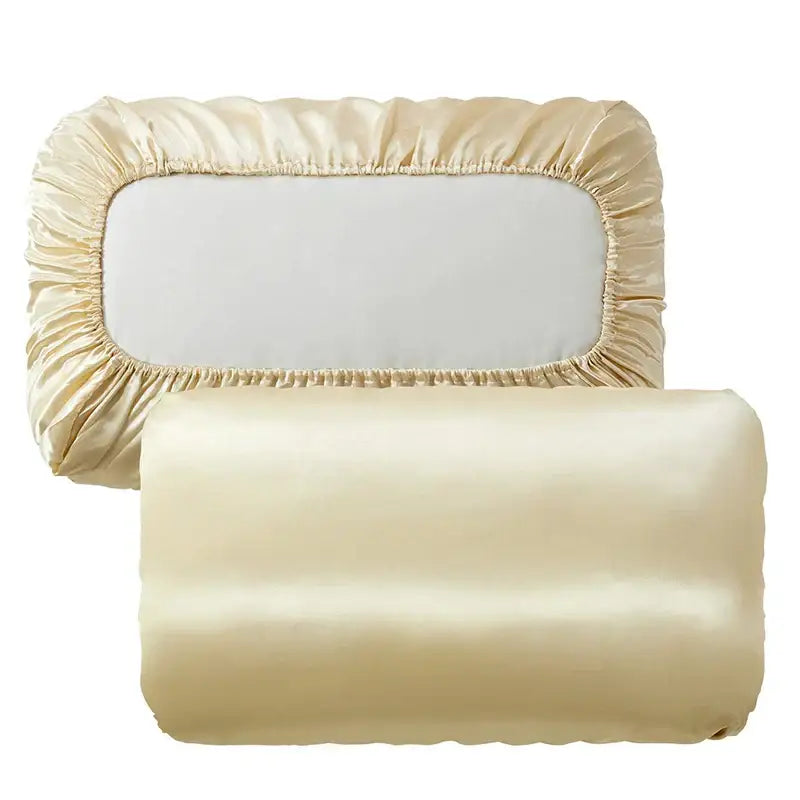 Cream-colored satin pillowcase and matching rolled-up pillow sham with decorbites imitation silk elastic band features