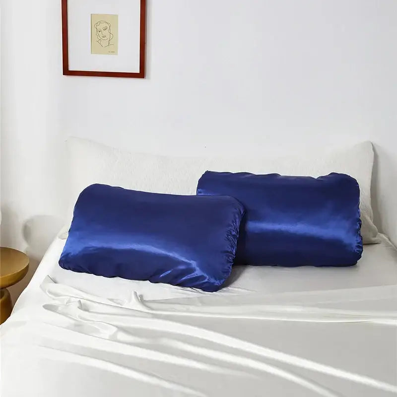 Two royal blue satin pillowcases with a smooth finish featuring decorbites imitation silk elastic band for bedding