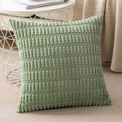 A soft sage green textured throw pillow with a raised woven pattern complementing decorbites corduroy striped cushion cover