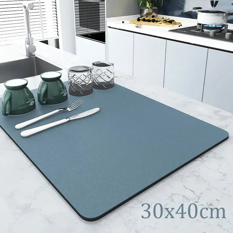 Teal rectangular silicone decorbites coffee mat with black border and textured surface for kitchen drying use