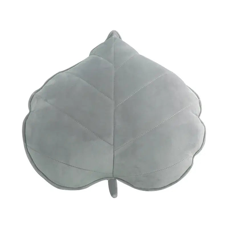 A soft light gray plush decorbites 3d leaf throw pillow with stitched veins and small stem for bedroom decor