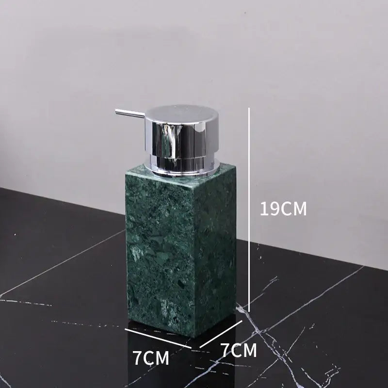 A sleek dark green marble soap dispenser with a polished chrome pump from the decorbites dark green bathroom set