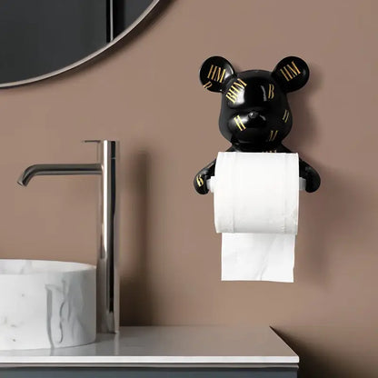 Dark green resin paper towel holder shaped like a black bear with gold lettering holding white toilet paper