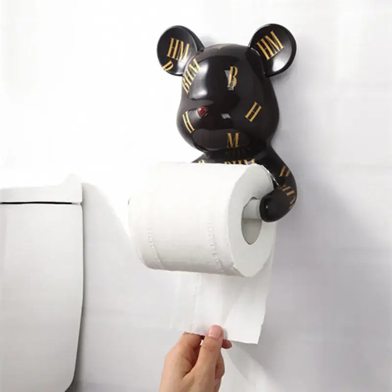 Dark green resin paper towel holder shaped like a black bear with gold roman numerals and a red nose holding white paper towel