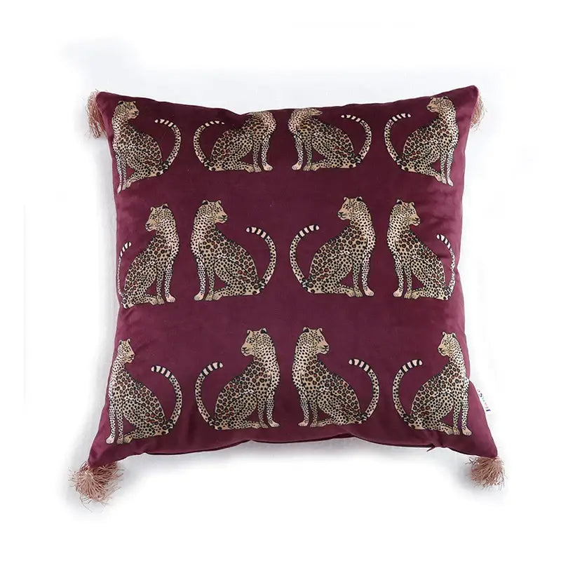 Maroon velvet cushion cover with embroidered beige and black seated leopards and matching tassels decorbites leopard cheetah print