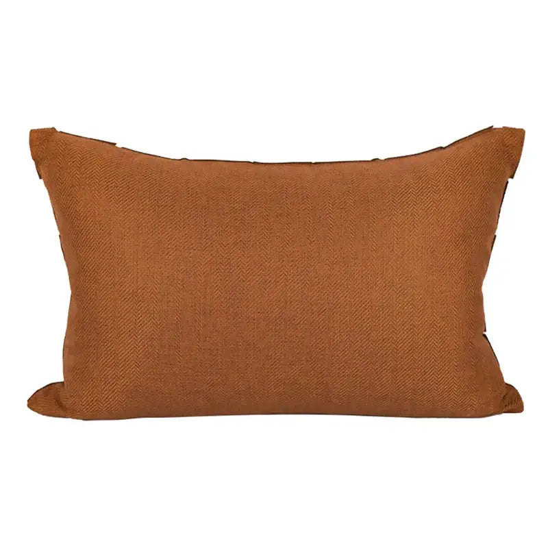 Dark orange geometric leather lumbar pillow cover with rust-colored textured herringbone weave decorbites style