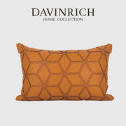 A tan leather pillow cover with dark orange geometric three-dimensional hexagonal stitching for decorbites decor