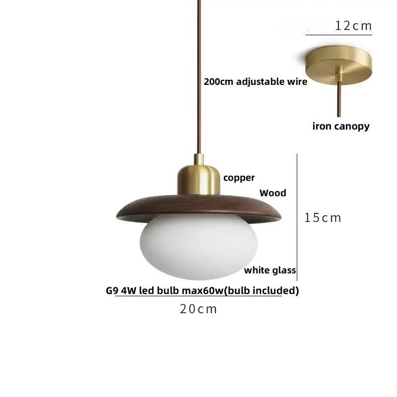 A dark wood and brass finished glass led pendant lamp with an oval white glass bulb for dining room lighting
