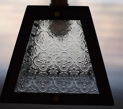 Dark wood and glass led pendant lamp with a black-framed embossed quatrefoil glass panel for dining room