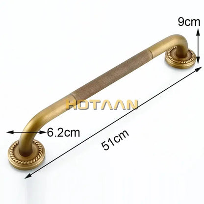 Antique brass bathroom safety grab bar with textured grip and ornate circular end caps for toilet use