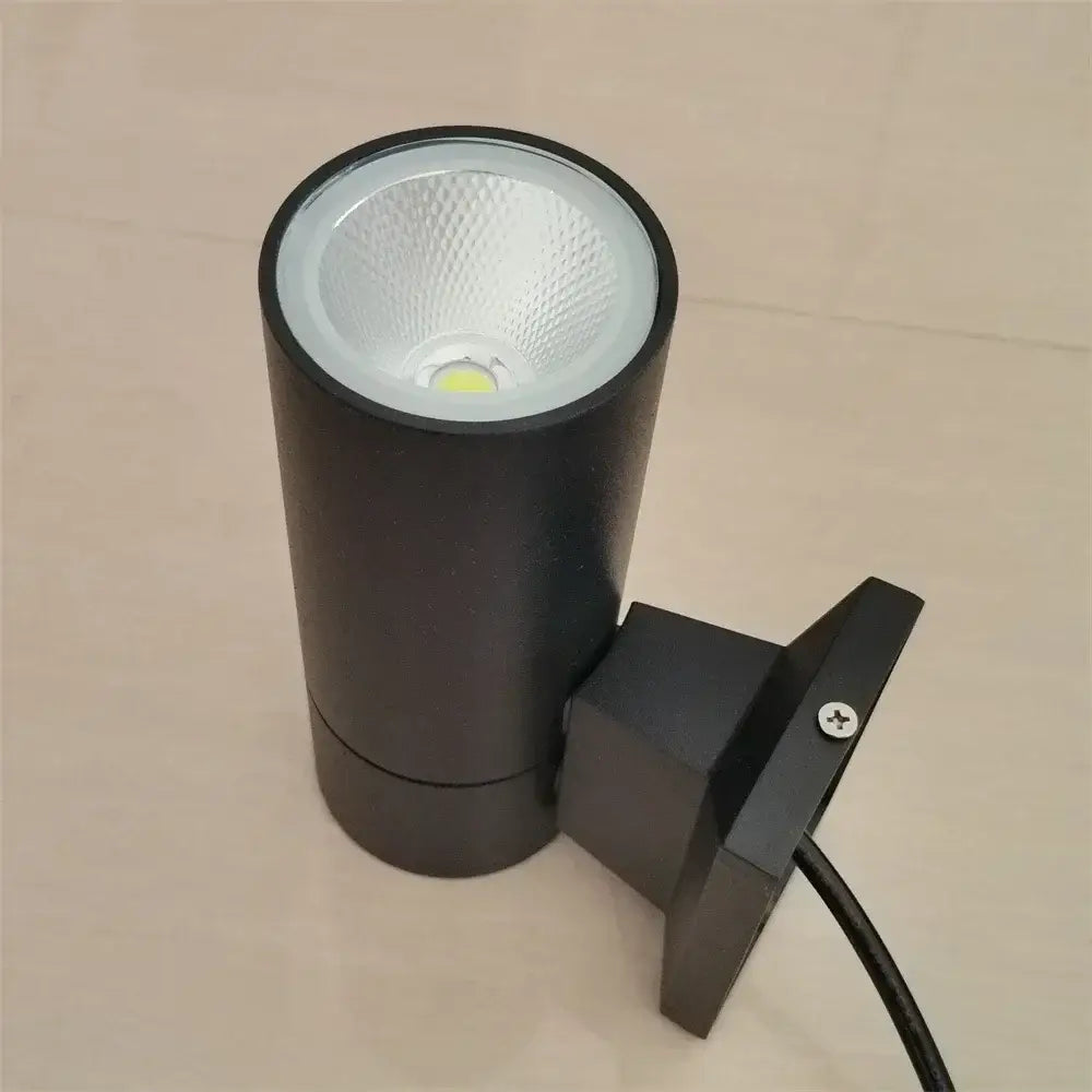 Modern black cylindrical 10w light wall outdoor porch spotlight with textured white reflector and mounting bracket