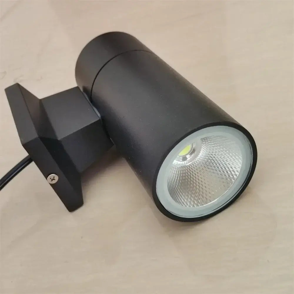 Modern black cylindrical 10w light wall outdoor porch spotlight with textured lens and mounting bracket