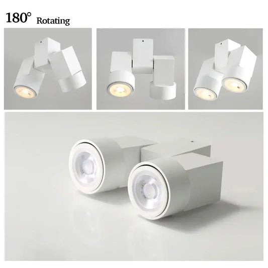 Modern white downlight surface mount with sleek geometric design and 180 degree rotating heads for living room use