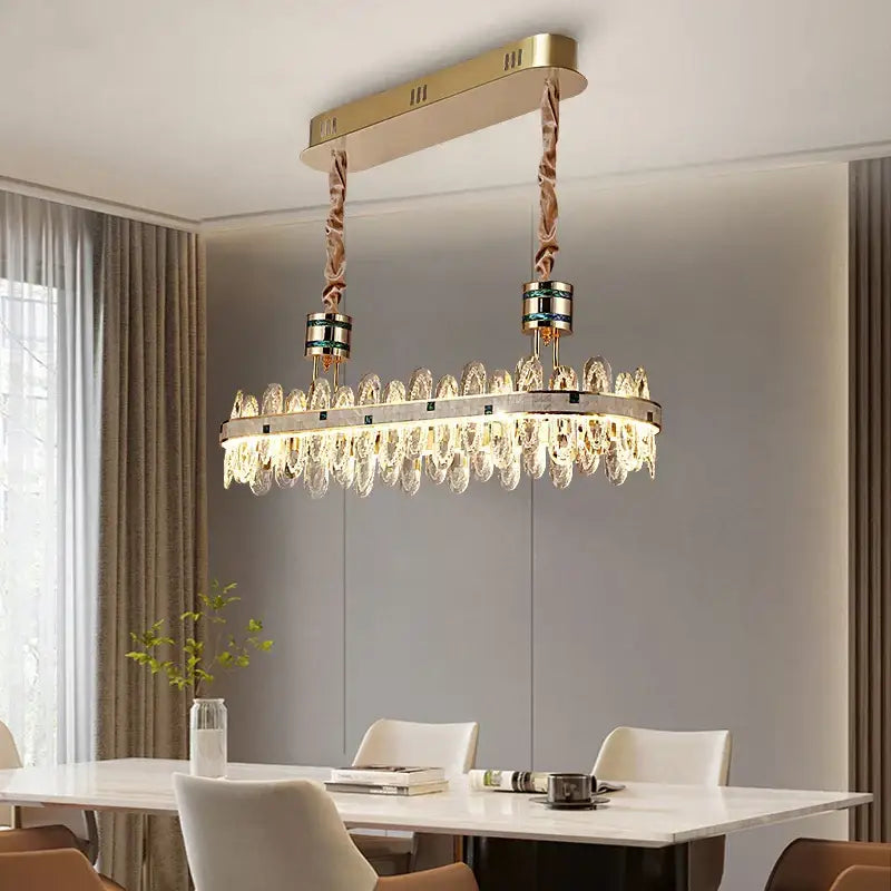 Gold-toned villa crystal chandelier with rectangular frame, dangling crystal droplets, and braided rope suspension for living room
