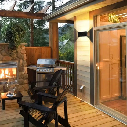 Modern black minimalist 24w led wall light outdoor sconce shown above black wooden adirondack chairs on a deck
