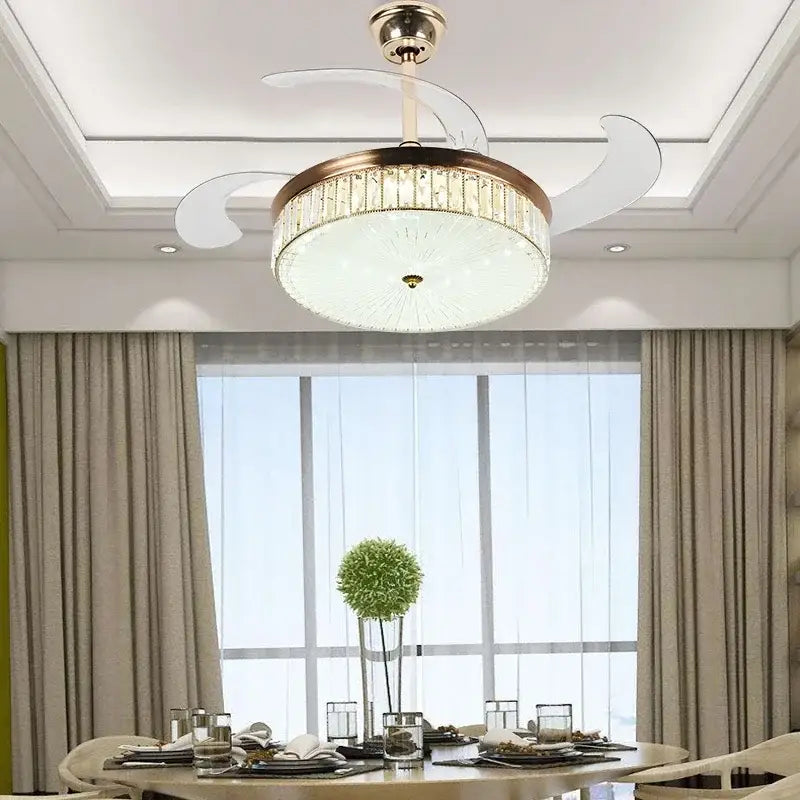 Modern gold ceiling fan with retractable blades and crystal accents featuring integrated lighting and remote control