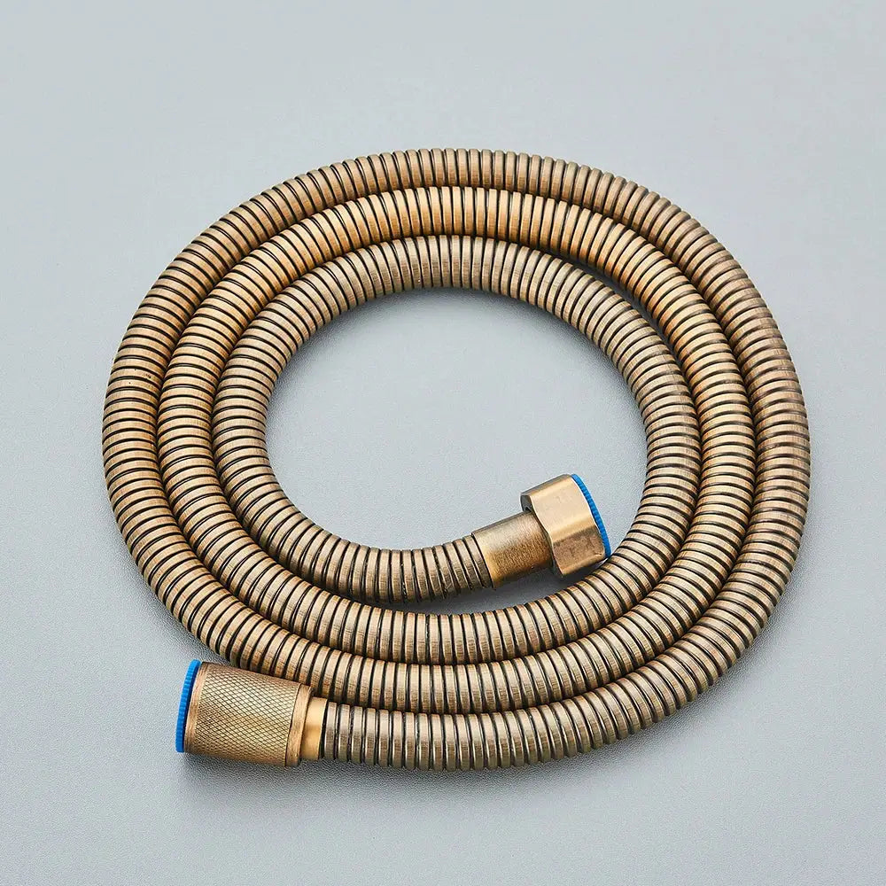 A coiled black bronze flexible shower hose with ribbed texture and blue rubber caps for bathroom hand shower replacement