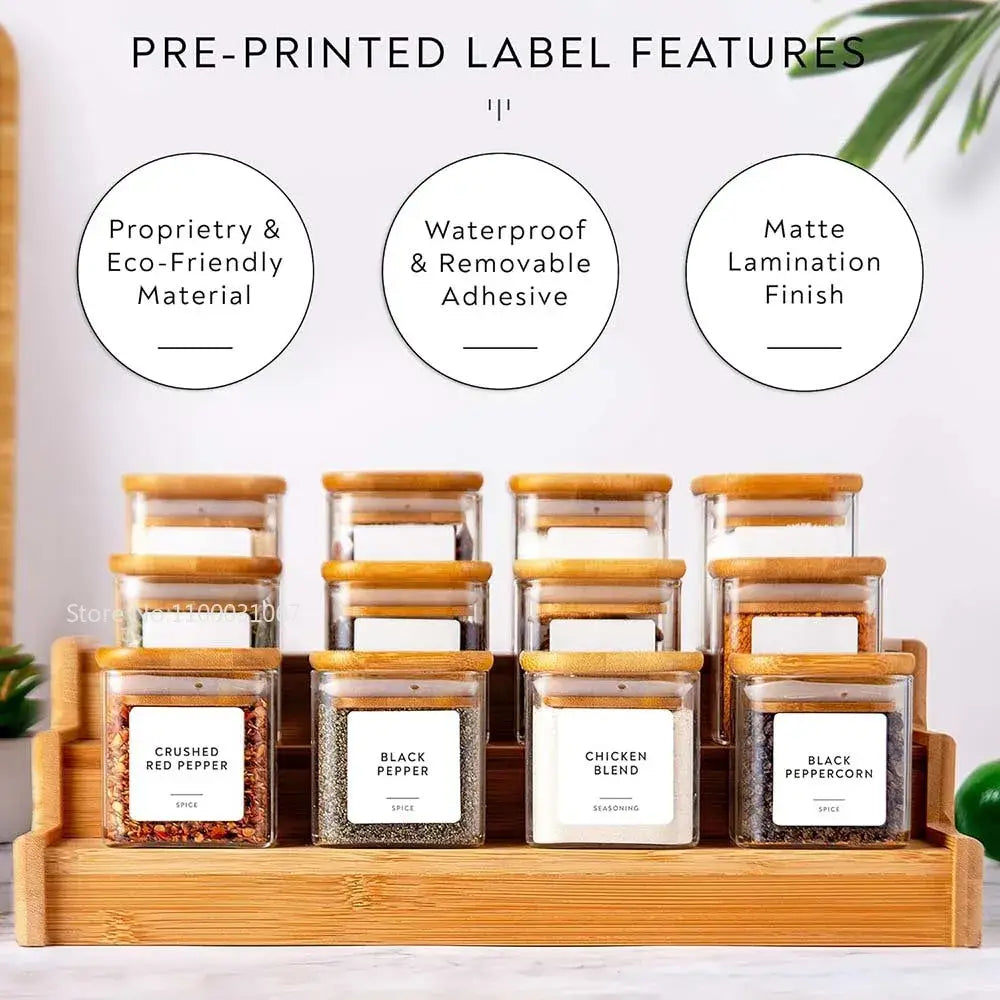 Set of clear decorbites 5oz glass jars with bamboo lids and labels arranged on wooden tray for tea and coffee storage