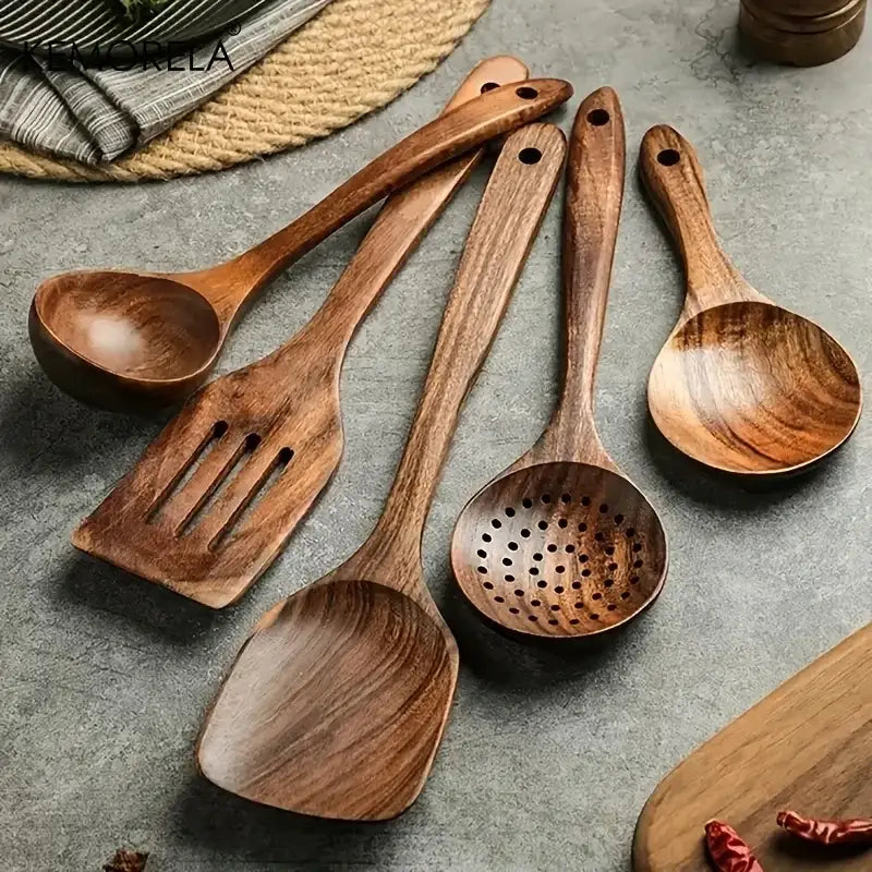 Set of five handcrafted teak wooden cooking spoons in warm brown tones with natural wood grain patterns
