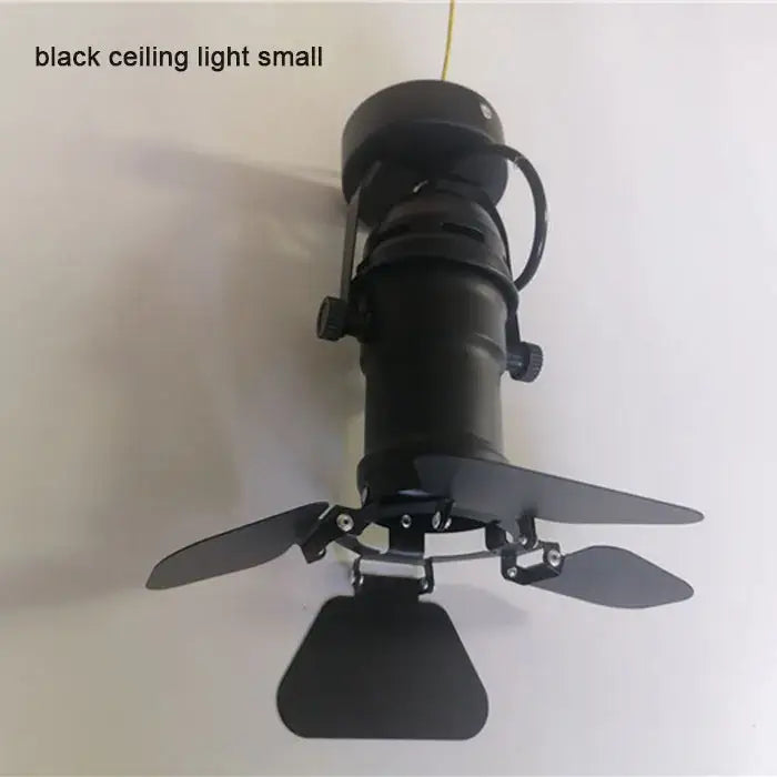 Black industrial-style DecorBites™ 5w cob led track light with adjustable metal blades and cylindrical body for clothing stores