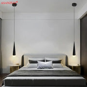 Black conical pendant light with silver black aluminum tube design hanging symmetrically above bed by DecorBites™