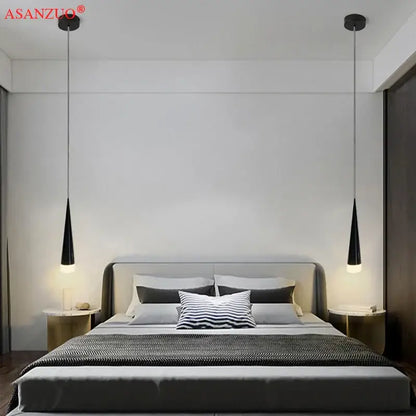 Black conical pendant light with silver black aluminum tube design hanging symmetrically above bed by DecorBites™