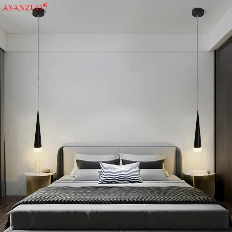 Black conical pendant light with silver black aluminum tube design hanging symmetrically above bed by DecorBites™