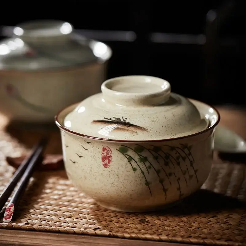 Cream-colored retro ceramic ramen bowl set with lid featuring hand-painted green vine and red floral designs by DecorBites™