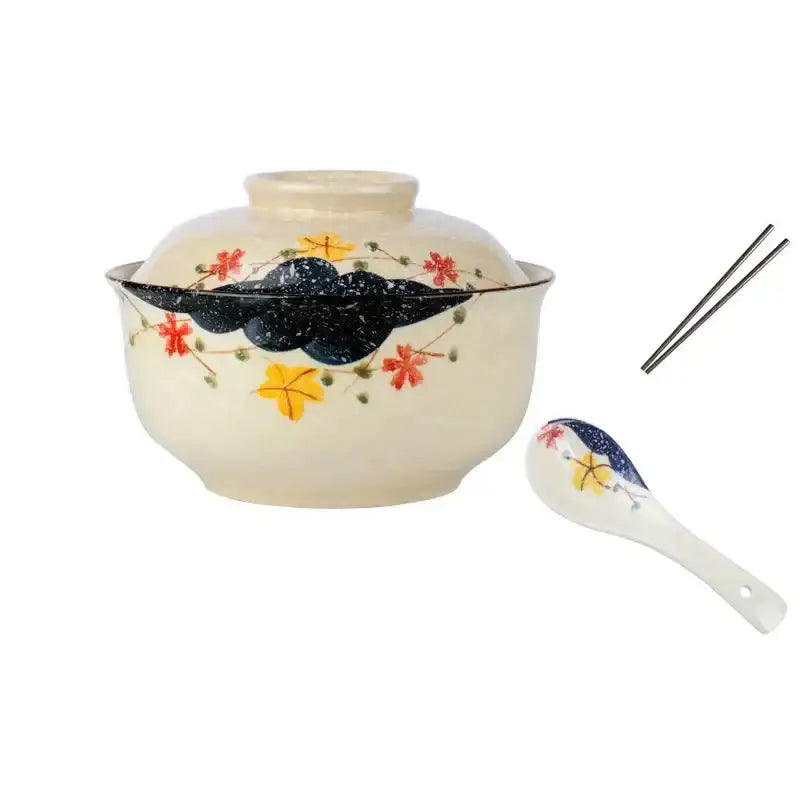 Cream-colored ceramic ramen bowl set with lid featuring hand-painted autumn leaves and dark blue cloud motifs by DecorBites
