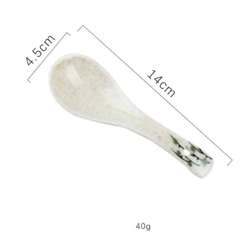 A delicate off-white ceramic spoon rest with green floral design included in decorbites™ retro ceramic ramen bowl set