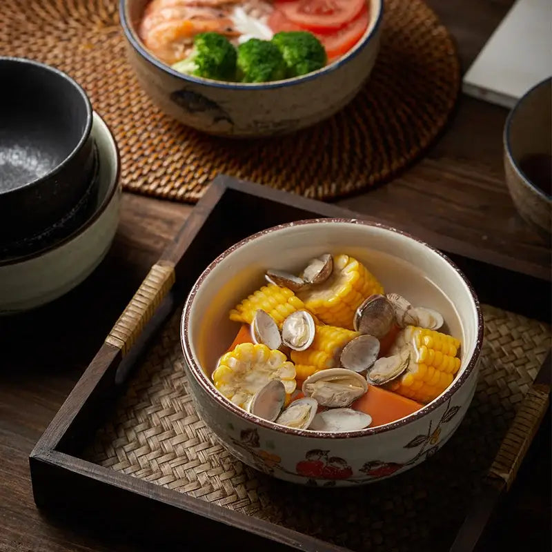 Decorbites™ ceramic ramen bowl with hand-painted floral pattern brown rim filled with corn and clams in broth
