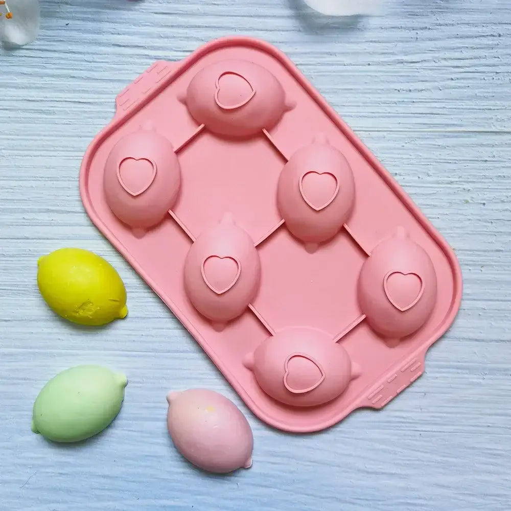 Pink lemon shape silicone cake mold with six cavities and heart cutouts for diy baking and decorating by decorbites