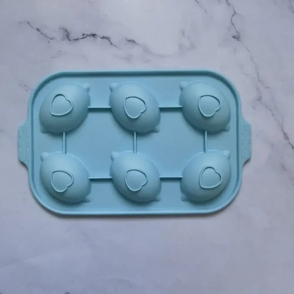 Decorbites™ light blue silicone cake mold shaped like six cartoon pigs with heart cutouts ideal for diy baking