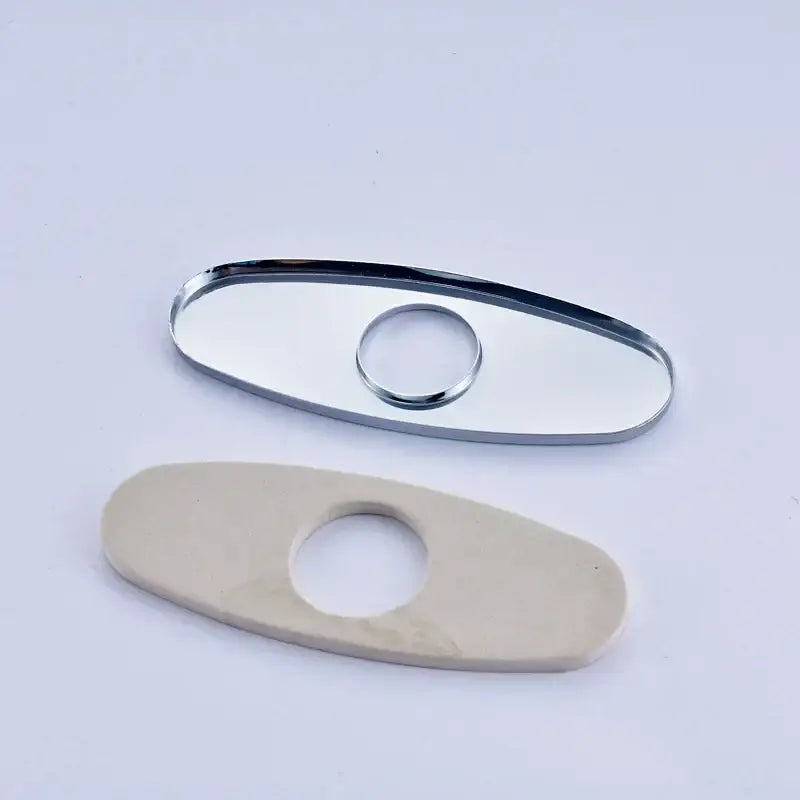 Chrome-finished oval deck plate cover with central hole paired with off-white ceramic plate cover for bathroom sink faucet