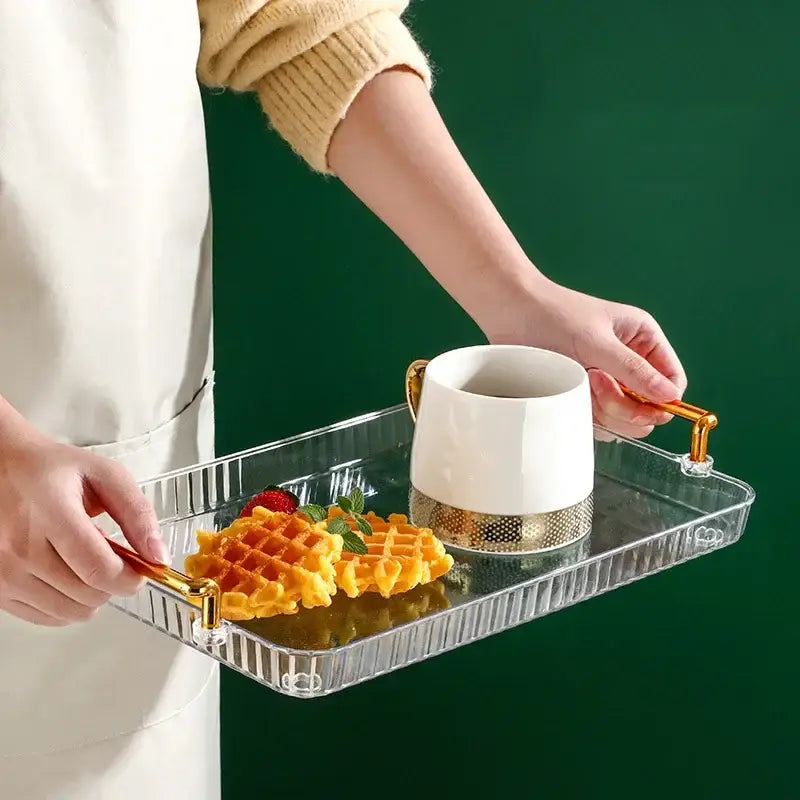 DecorBites 6-grid divided fruit plate is a clear rectangular tray with gold-tone handles holding a white ceramic mug and golden waffle