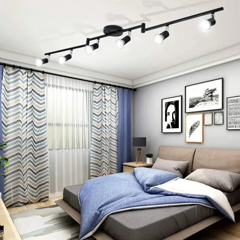 Black DecorBites 6 head LED ceiling light with adjustable angle spot lamp mounted above the bed for bedroom use
