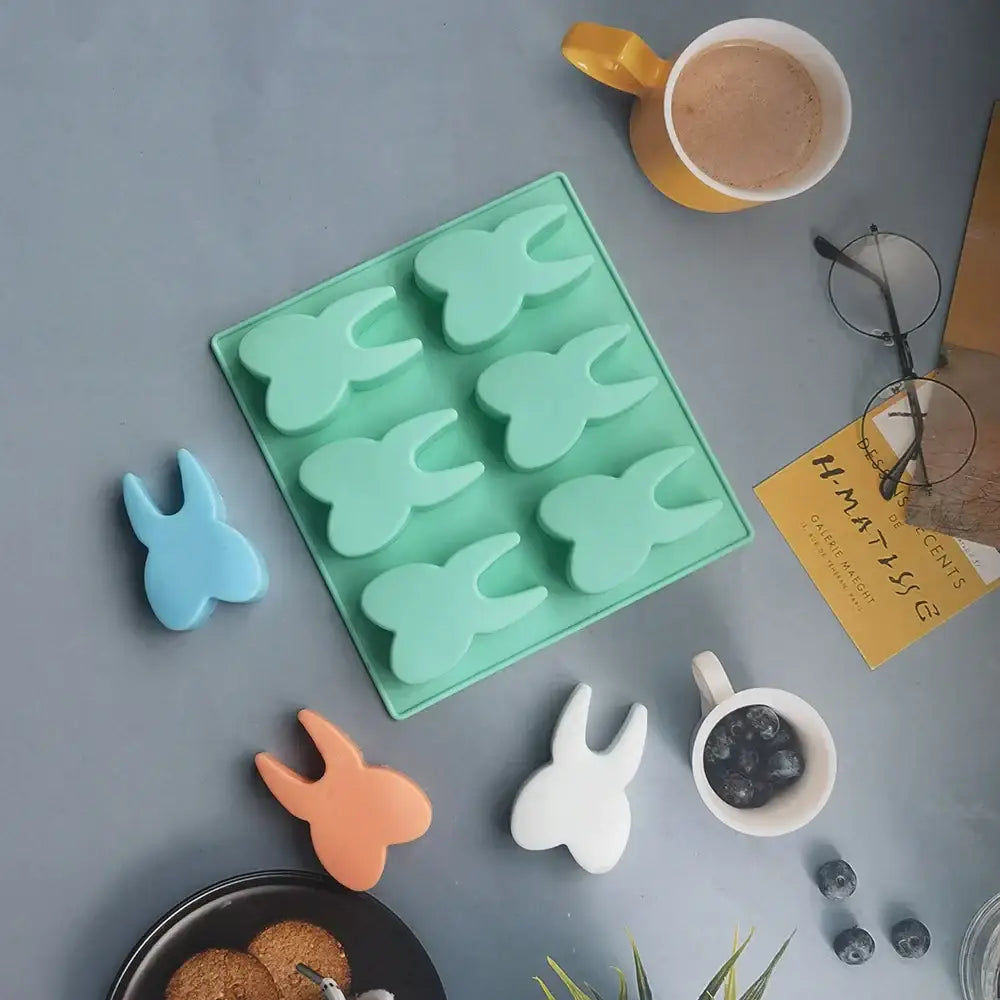 Mint green silicone mold with six cavities in bunny shapes for 3D cake and candy by DecorBites tooth silicone mold
