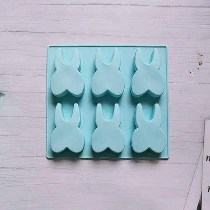 Light blue silicone mold with six bunny-shaped holes from decorbites™ 6 hole tooth silicone bakeware