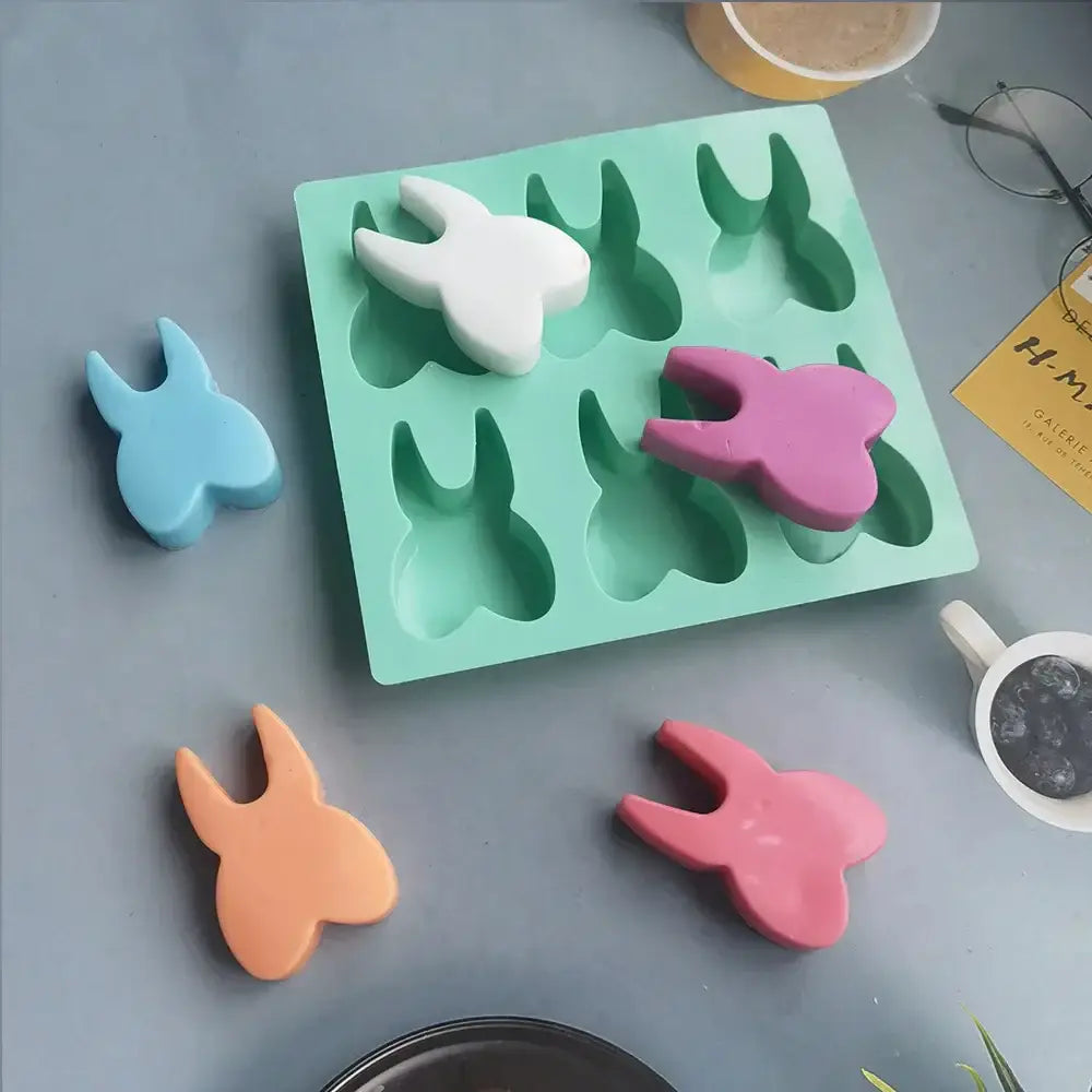 DecorBites™ mint green silicone mold with 6 hole tooth silicone rabbit shapes in white blue pink and orange