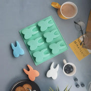 Mint green silicone mold featuring six bunny-shaped cavities from decorbites™ hole tooth silicone bakeware collection